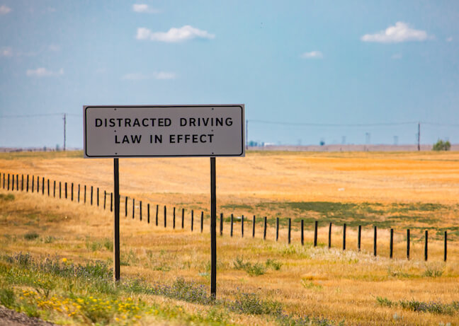 Distracted driving laws enforced sign.